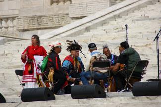 Group of indigenous men sitting in a drum circle