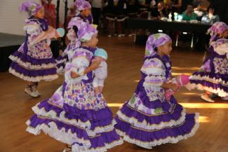 Colombian Dance Group girls with dolls