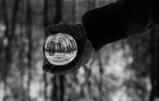 Gloved hand holding clear ball